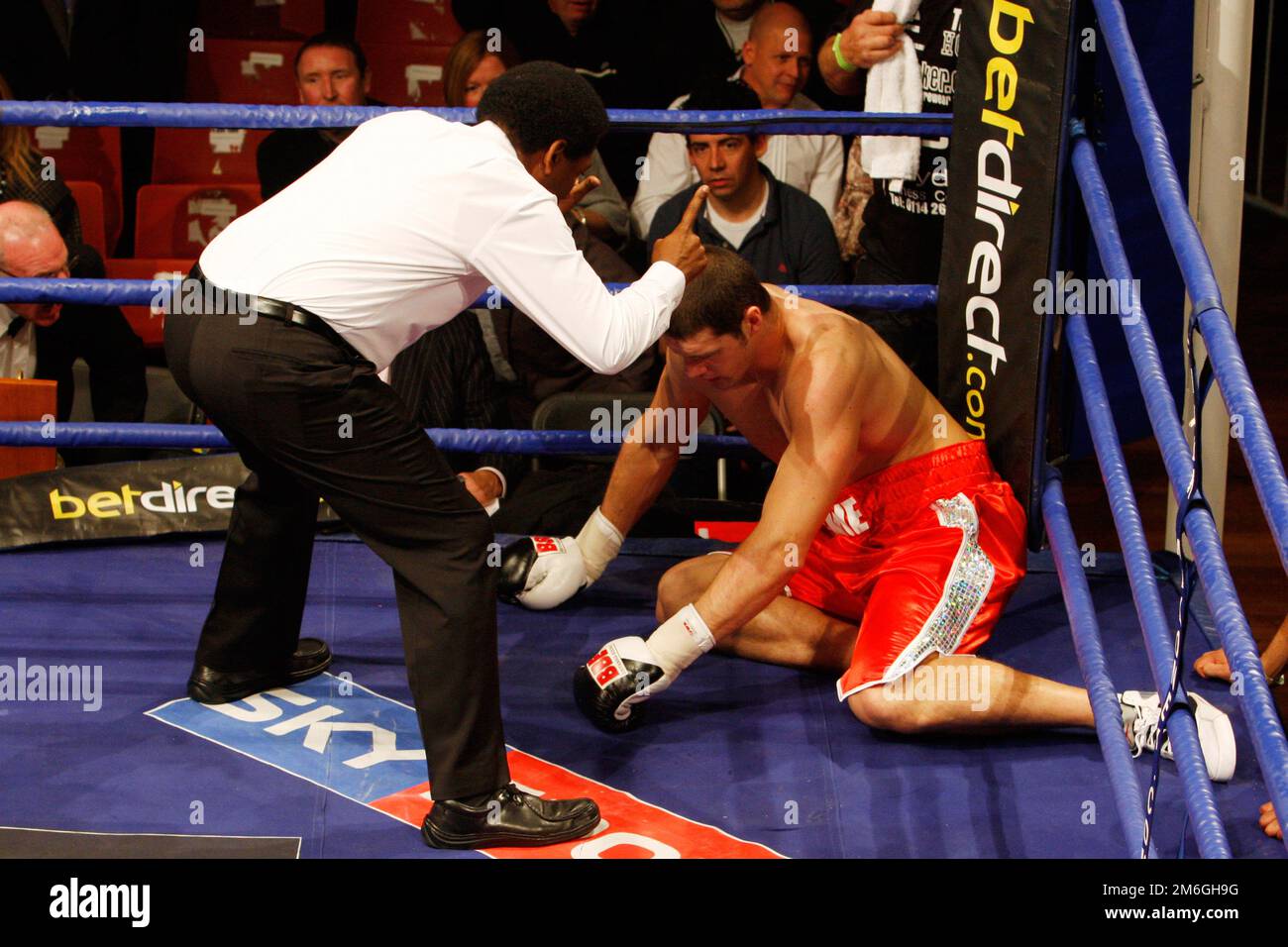a fighter is counted out by a referee after being knocked down Stock Photo