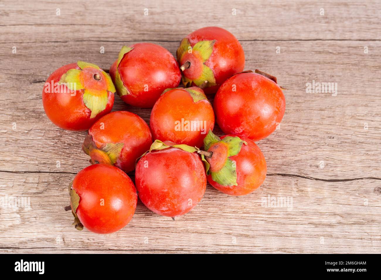Persimmons on wooden table background Stock Photo