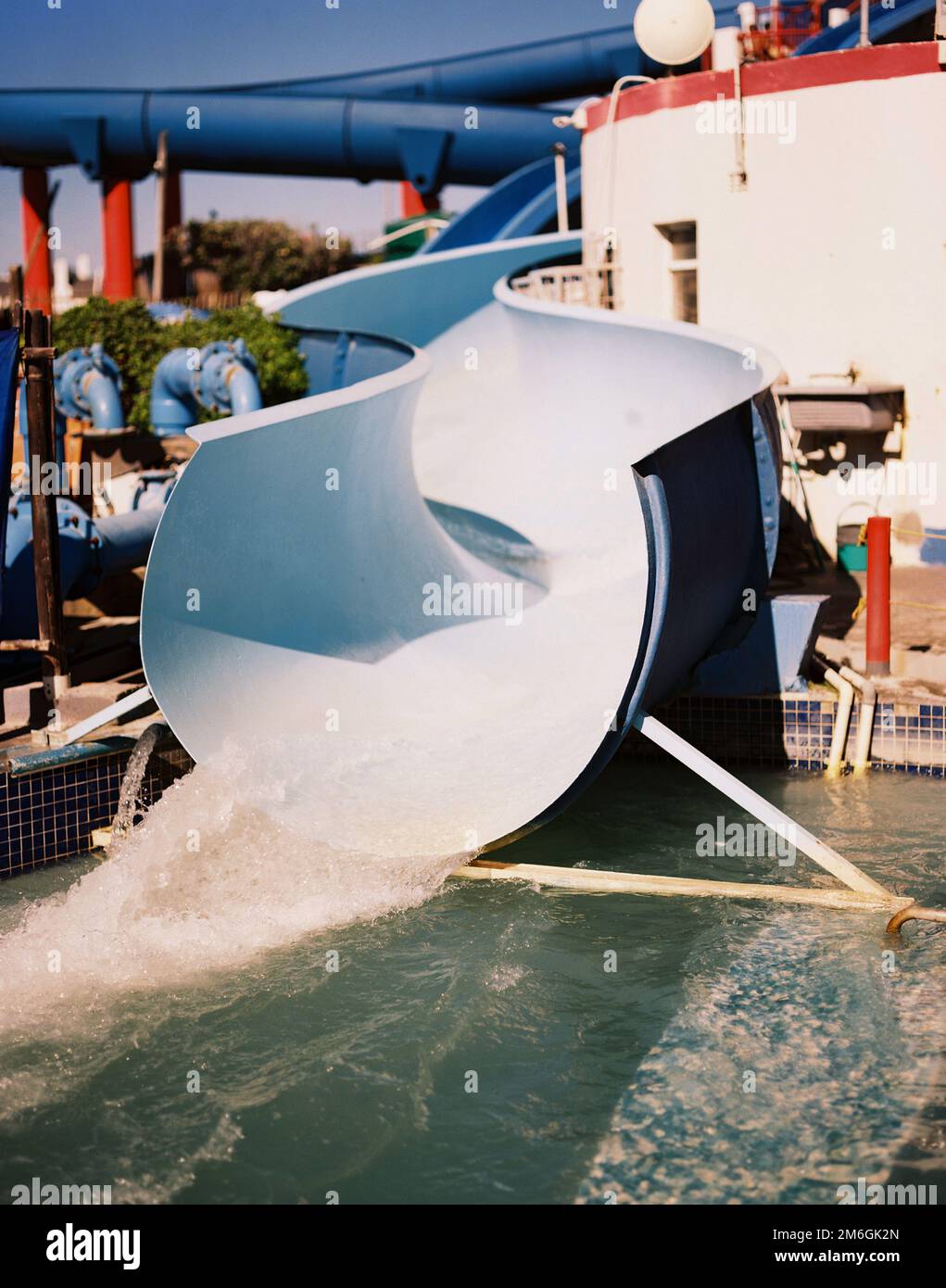 A vertical view of lonely 1960's waterslide on a sunny day Stock Photo