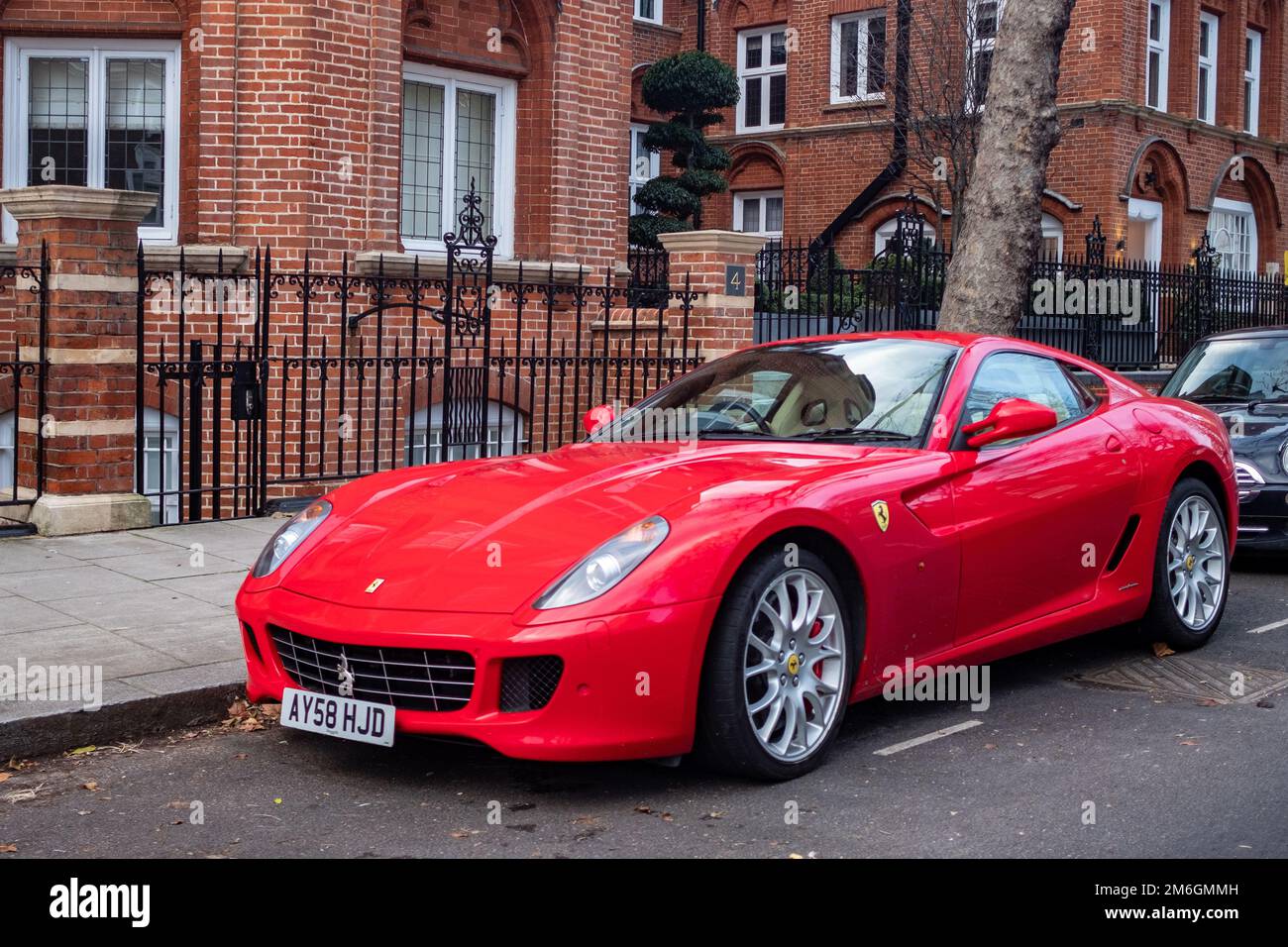 London- December 2022: Red Ferrari Roma car parked on upmarket Kensington street Stock Photo