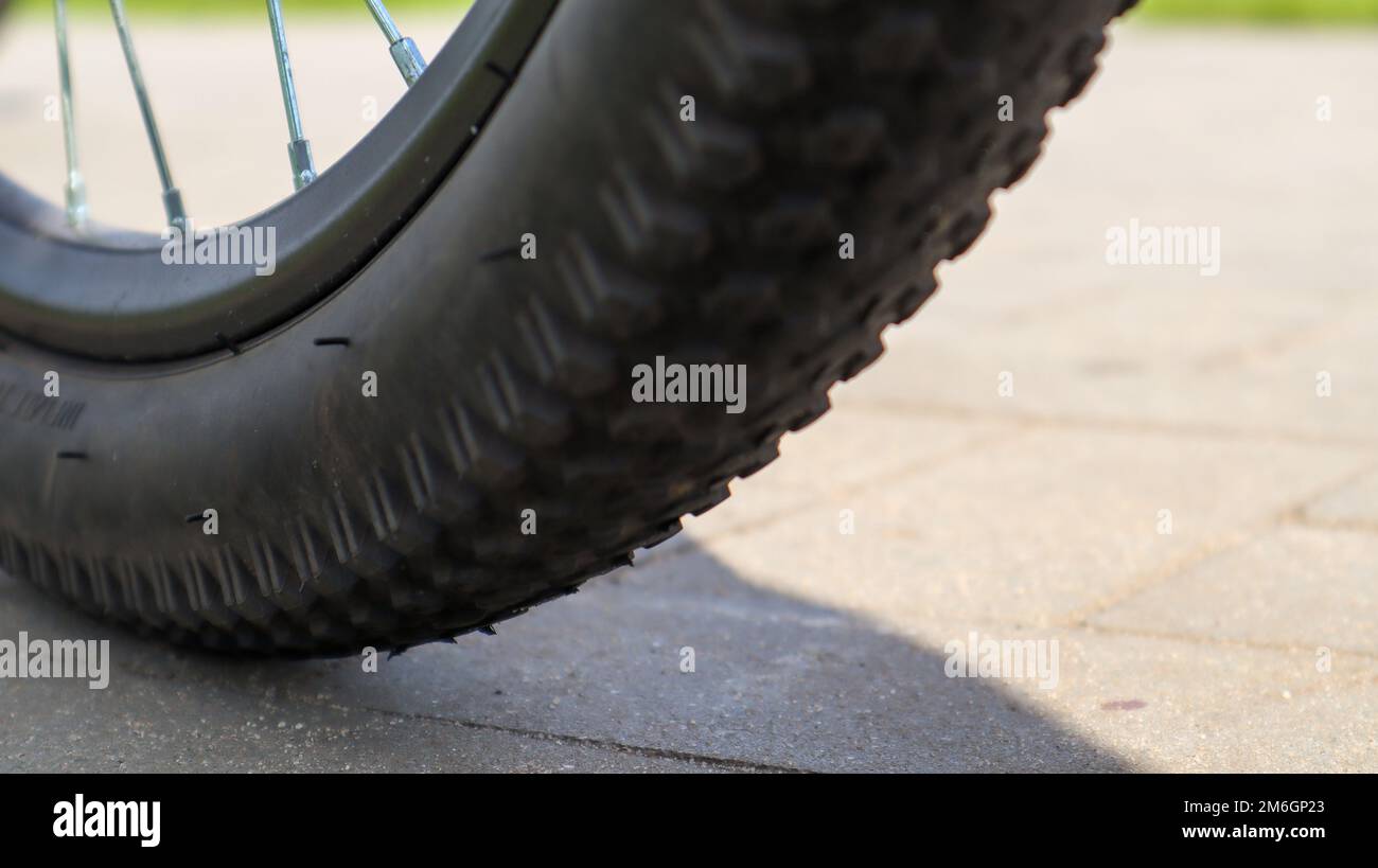 Mountain bike wheel and mud tire close. Stock Photo