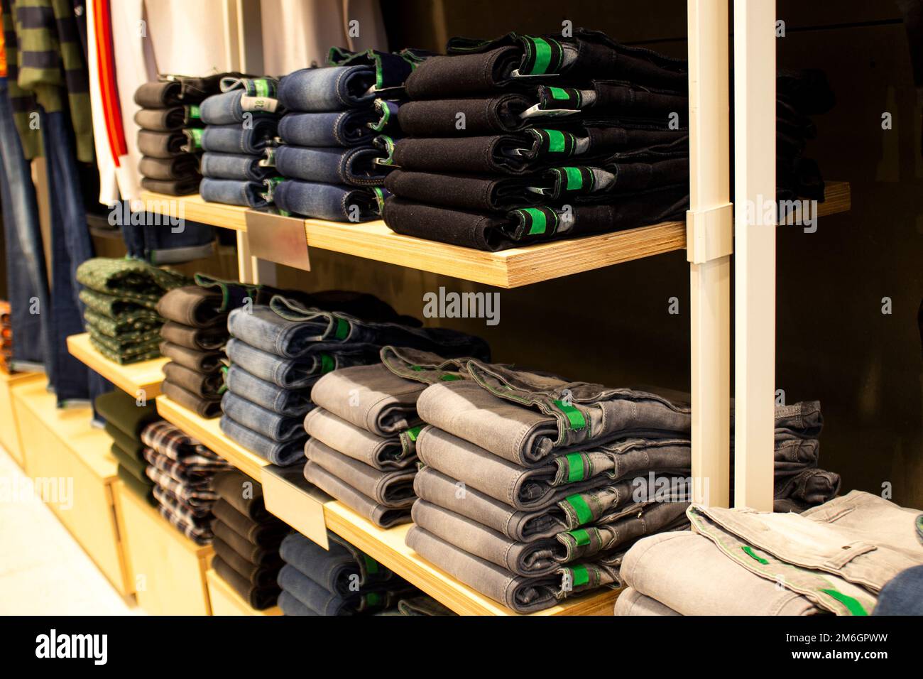 Shirt and pant hanging on hangers on a clothing rack and arranged in