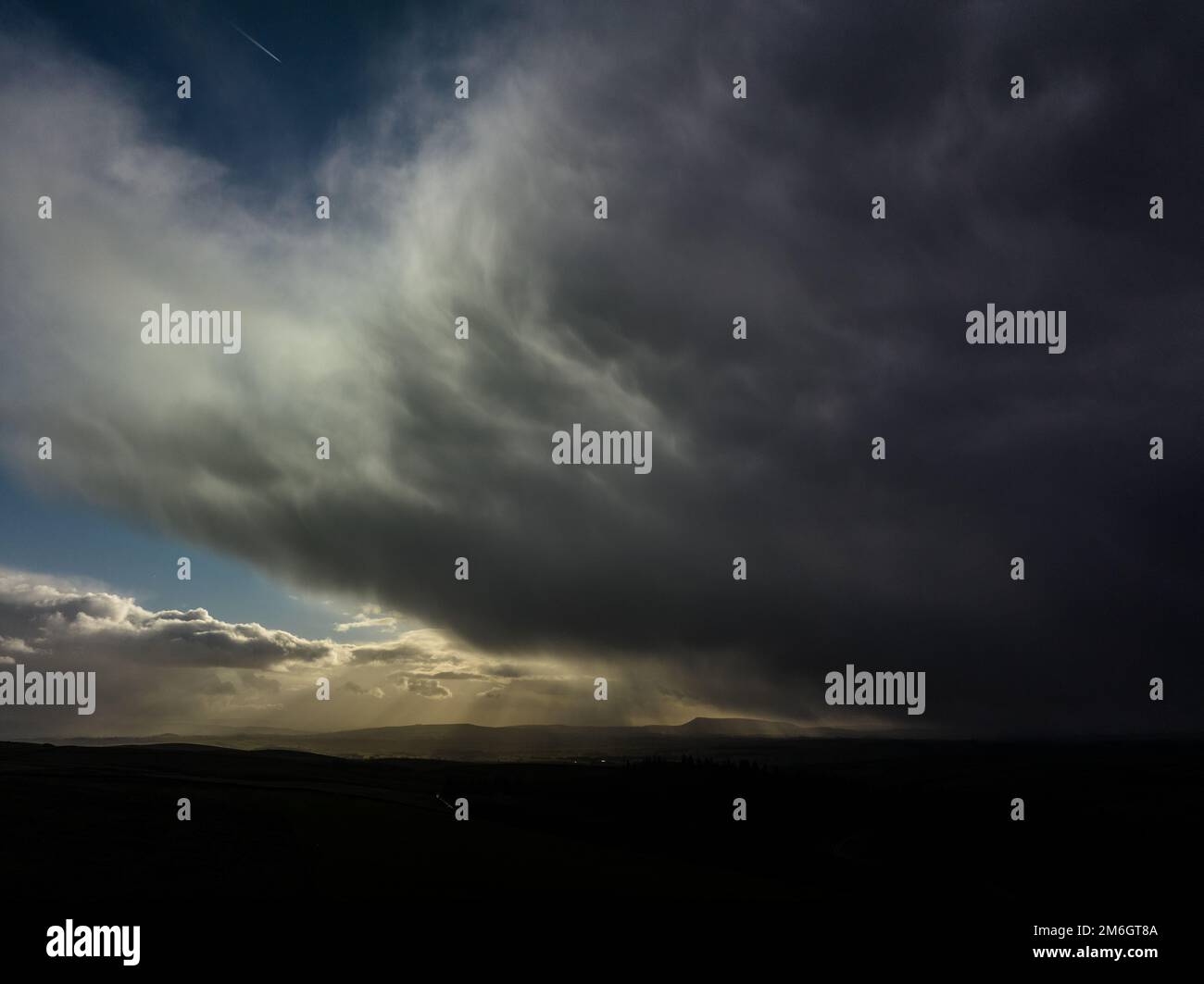 Rain Clouds shadow Pendle Hill in the distance Stock Photo