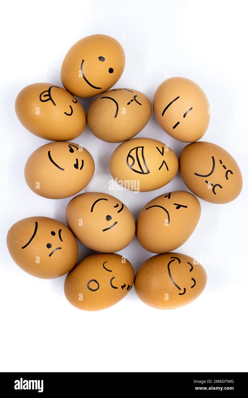 Many eggs with different reactions seen from above on white background Stock Photo
