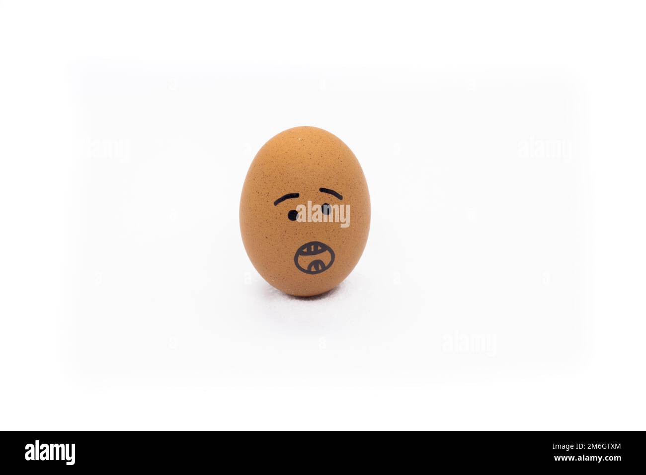 Egg with surprised face on white background Stock Photo