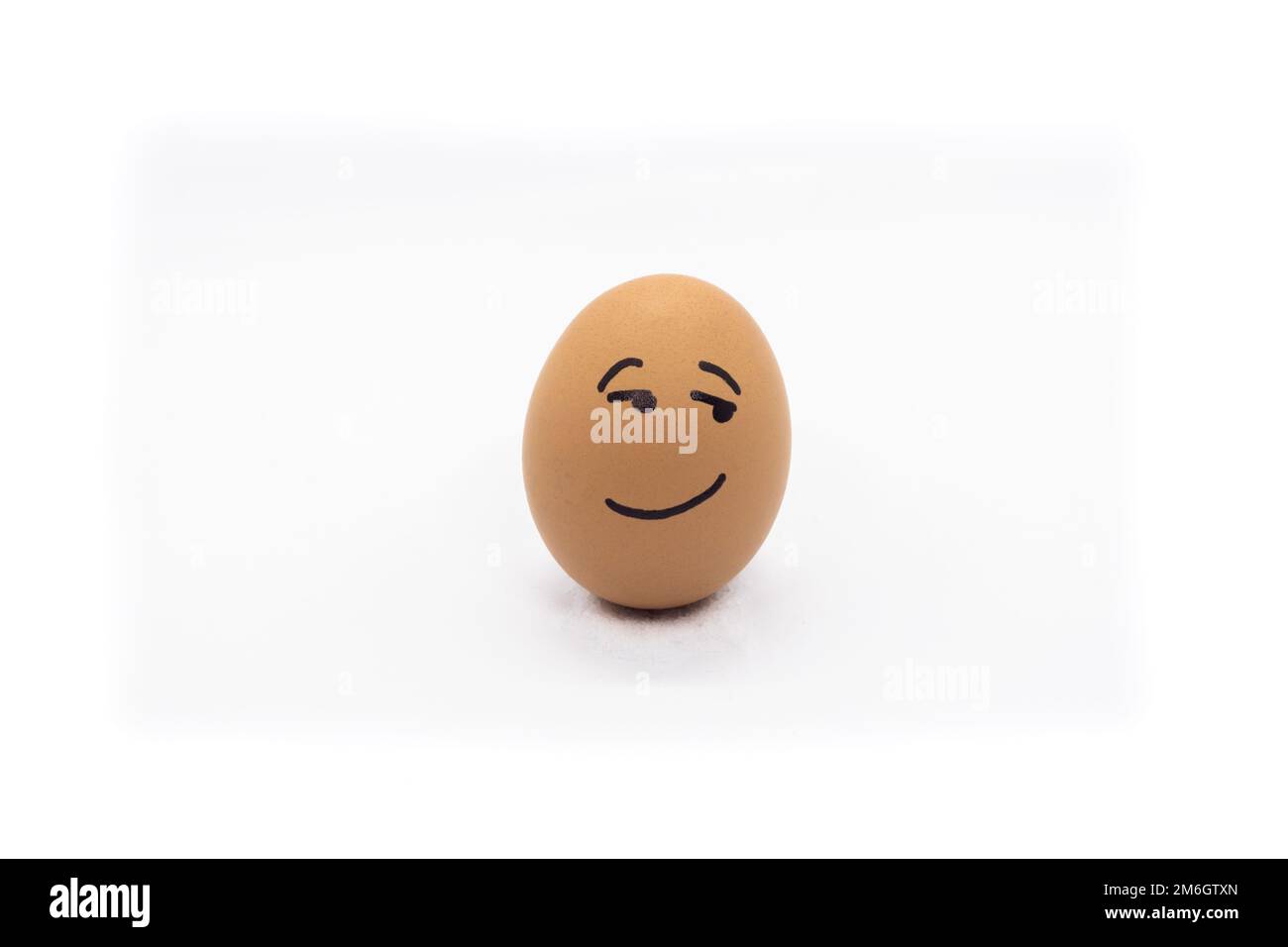 Egg with flirtatious face on white background Stock Photo