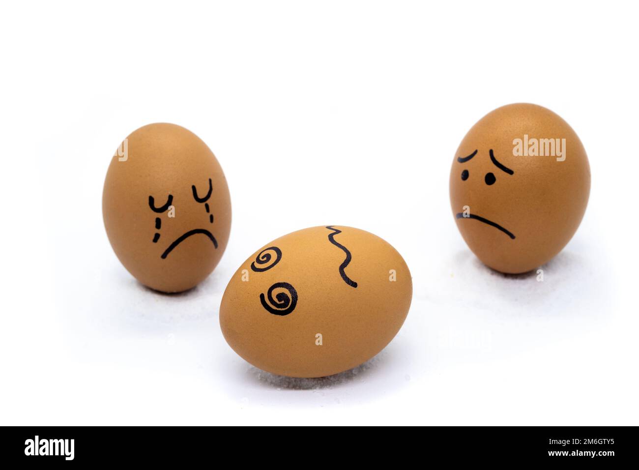 One egg crying, one egg worried, and one dead Stock Photo