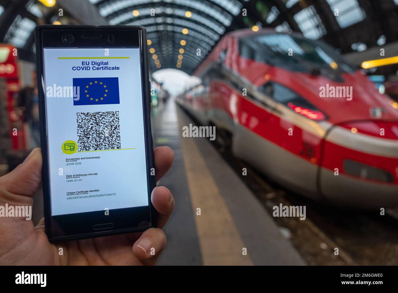 Woman showing on smartphone EU Digital Covid Certificate. Stock Photo