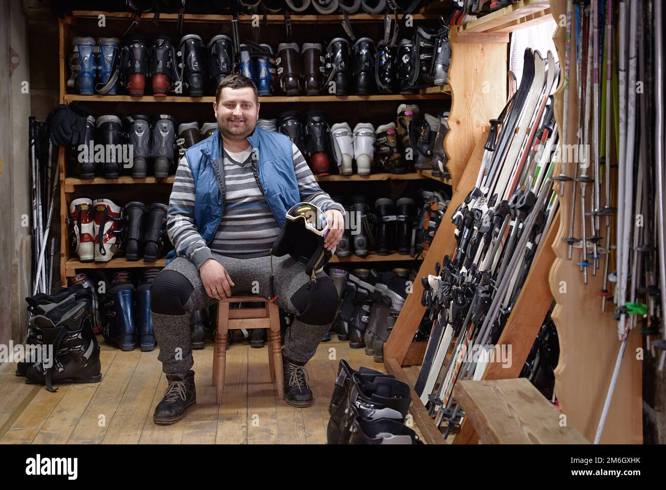 Portrait of cheerful SME ski rental service owner in an interior full