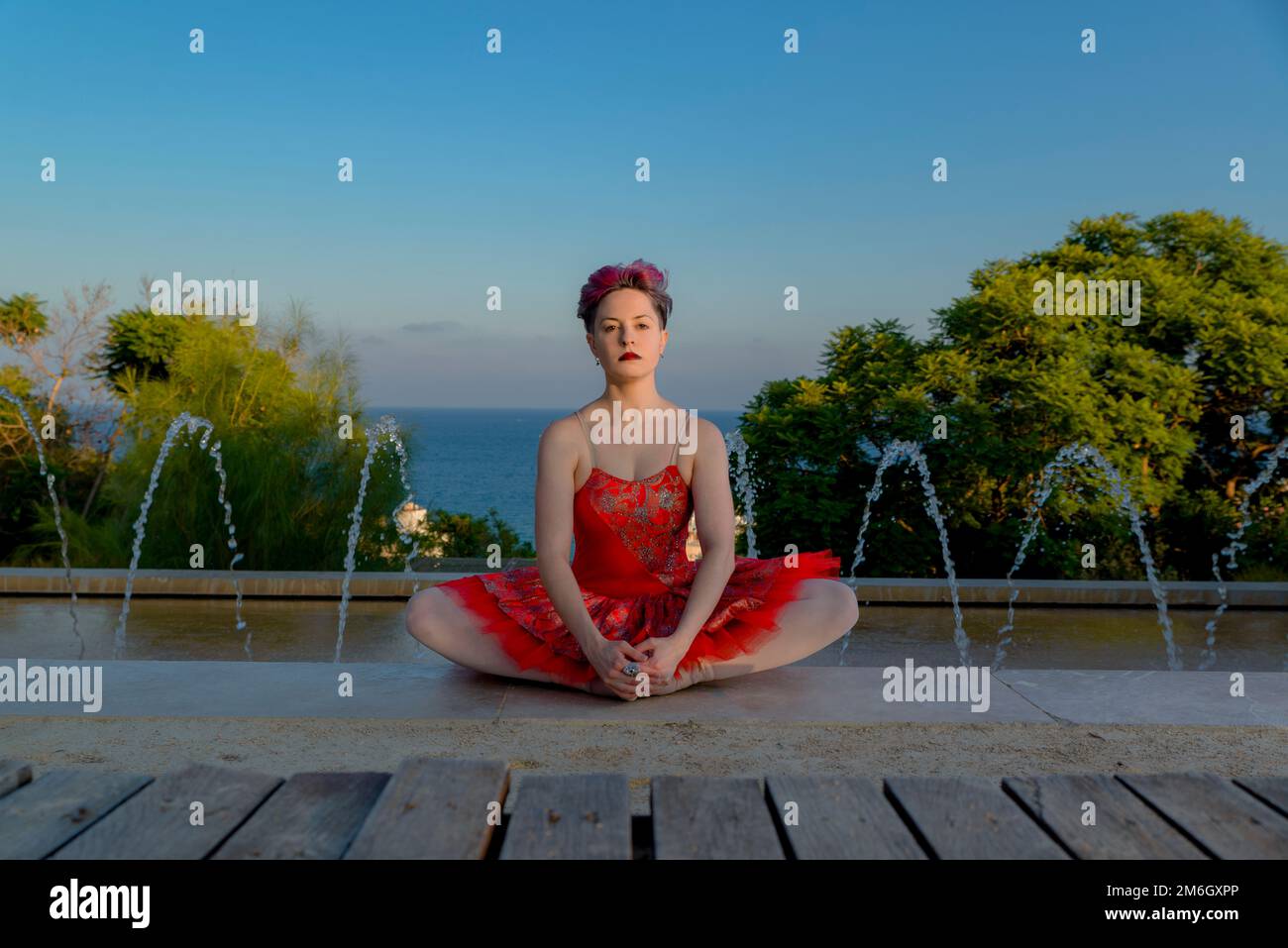 young ballet dancer girl with red outfit outdoors Stock Photo