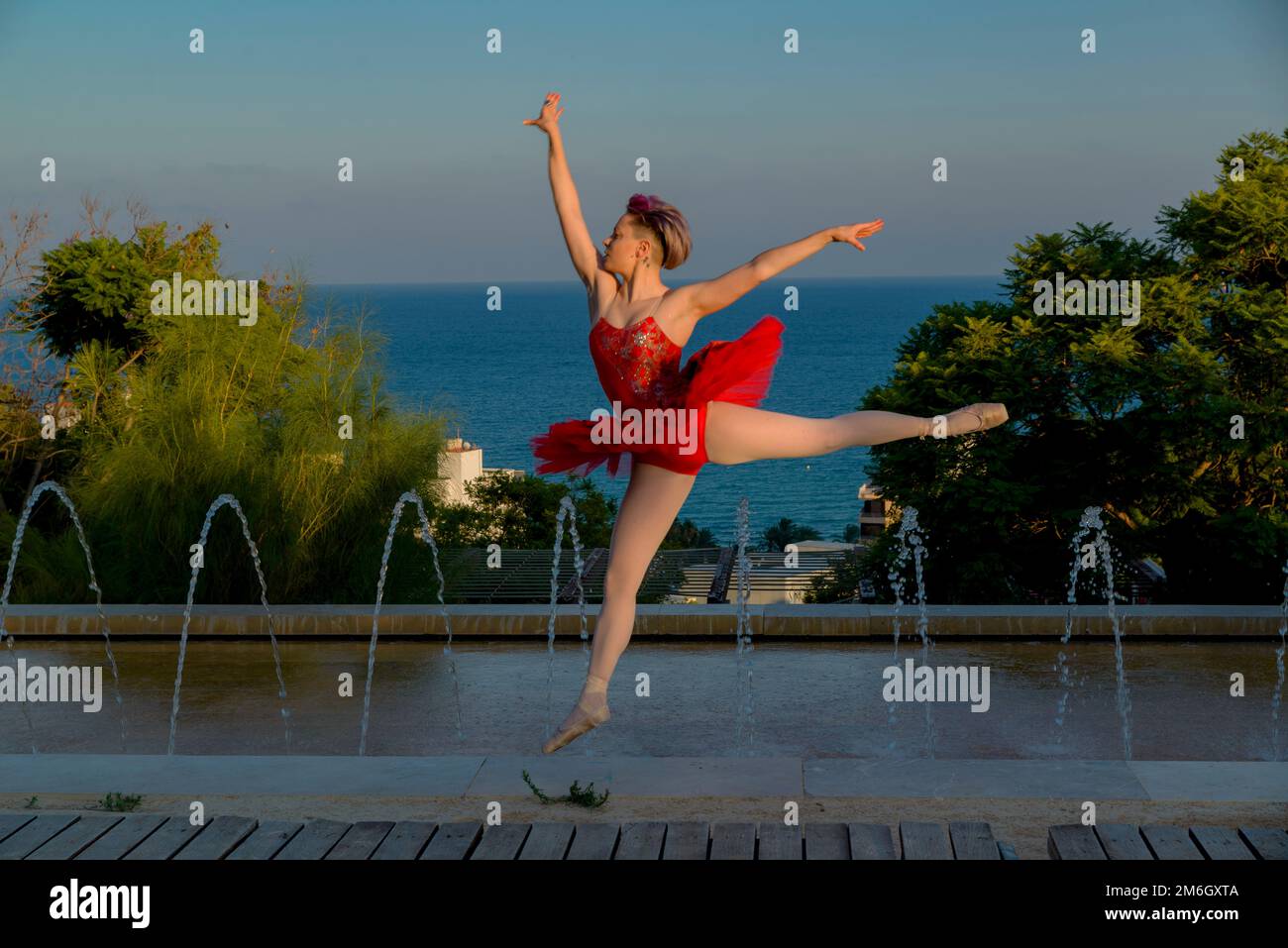 young ballet dancer girl with red outfit outdoors Stock Photo