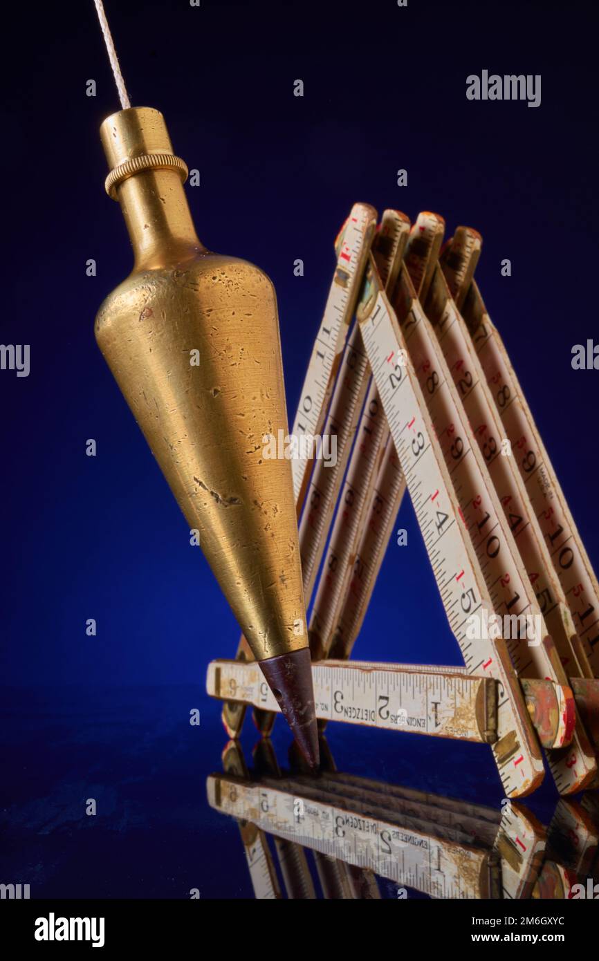 Plumb bob & carpenter's scale, antique surveying equipment Stock Photo