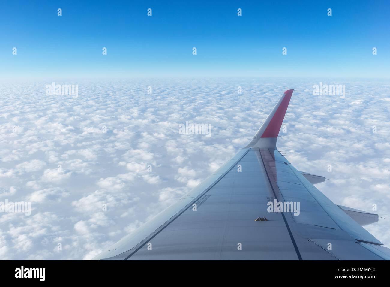 Airplane wing above the thick clouds Stock Photo Alamy