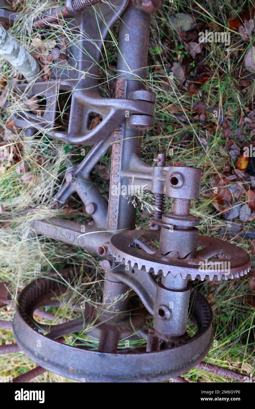 Bar mower is rusted and overgrown in a tree Stock Photo