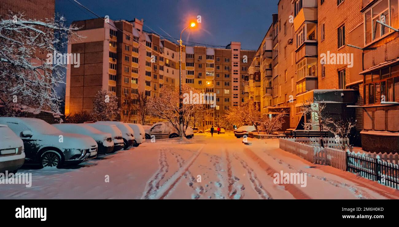 Bad weather in town. Thick layer of snow on parked cars. Urban scene. Weather concept Stock Photo