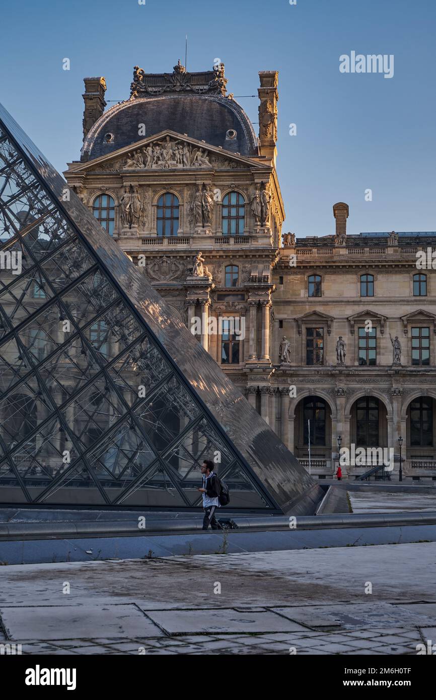 View of the famous Louvre museum and glass Pyramid at sunrise. The most