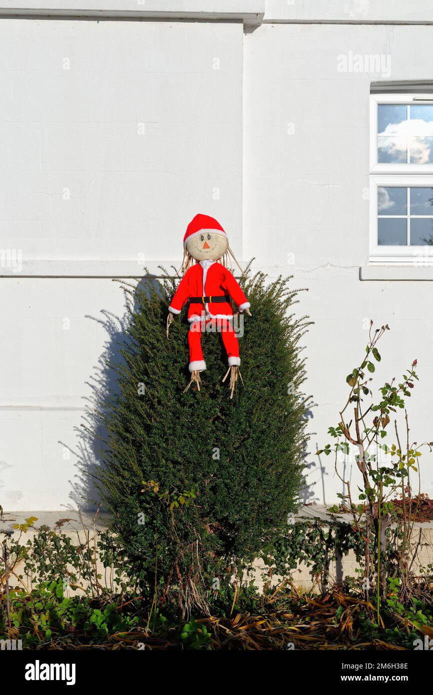 A crude but amusing small Father Christmas home made figure perched on