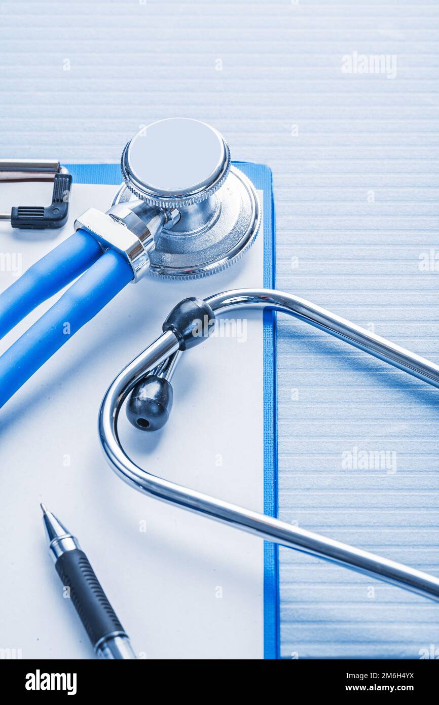 clipboard with white blank paper and stethoscope on blue background ...