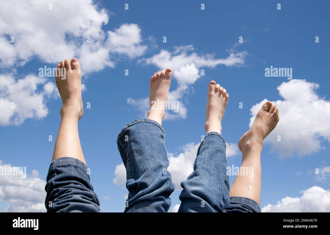Two sets of feet in the air Stock Photo Alamy