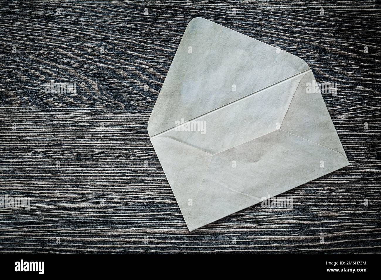 Opened vintage envelope on black board. Stock Photo