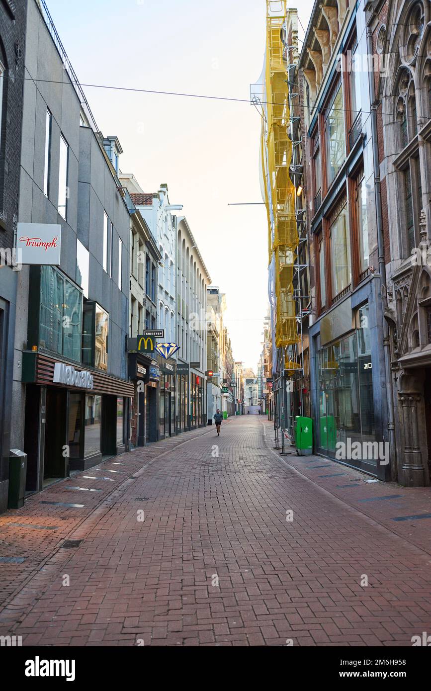 A view of a deserted Kalverstraat during Covid-19 lockdown, in the coronavirus pandemic in Amsterdam Stock Photo