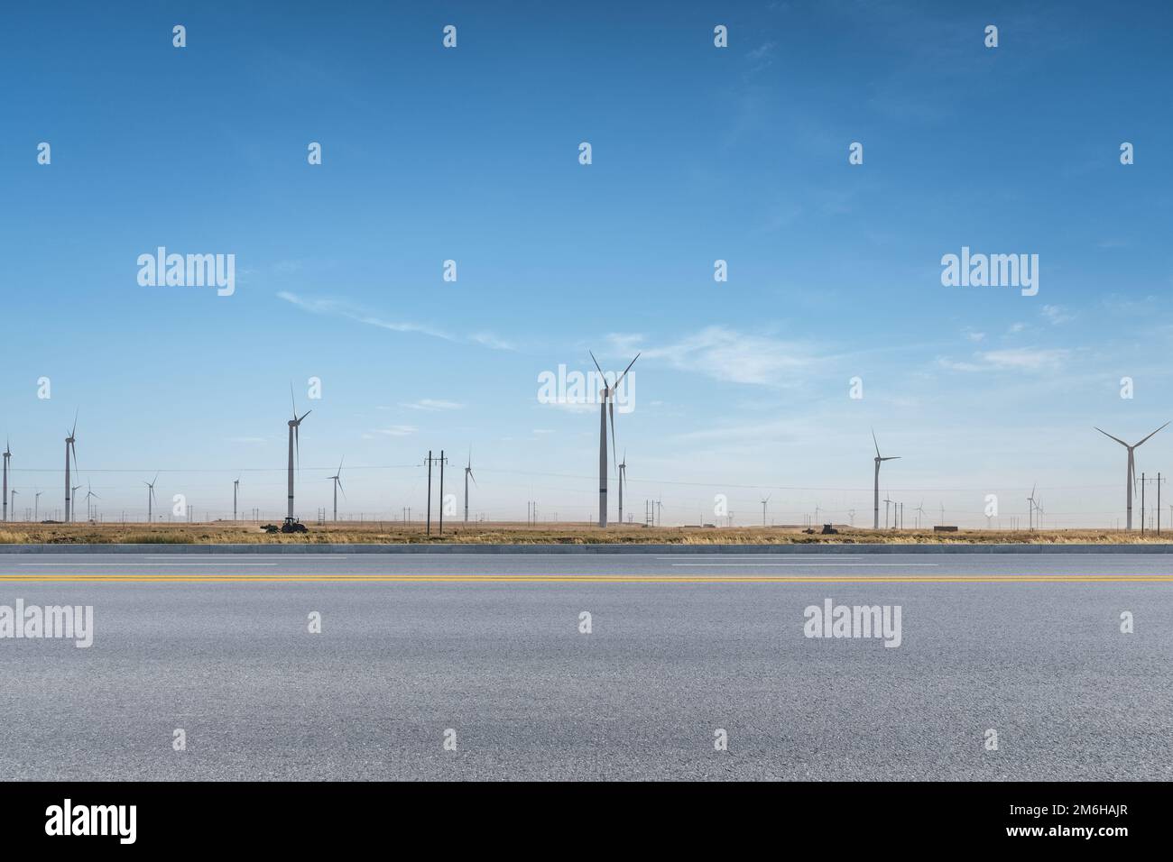 Wind turbines by the road Stock Photo