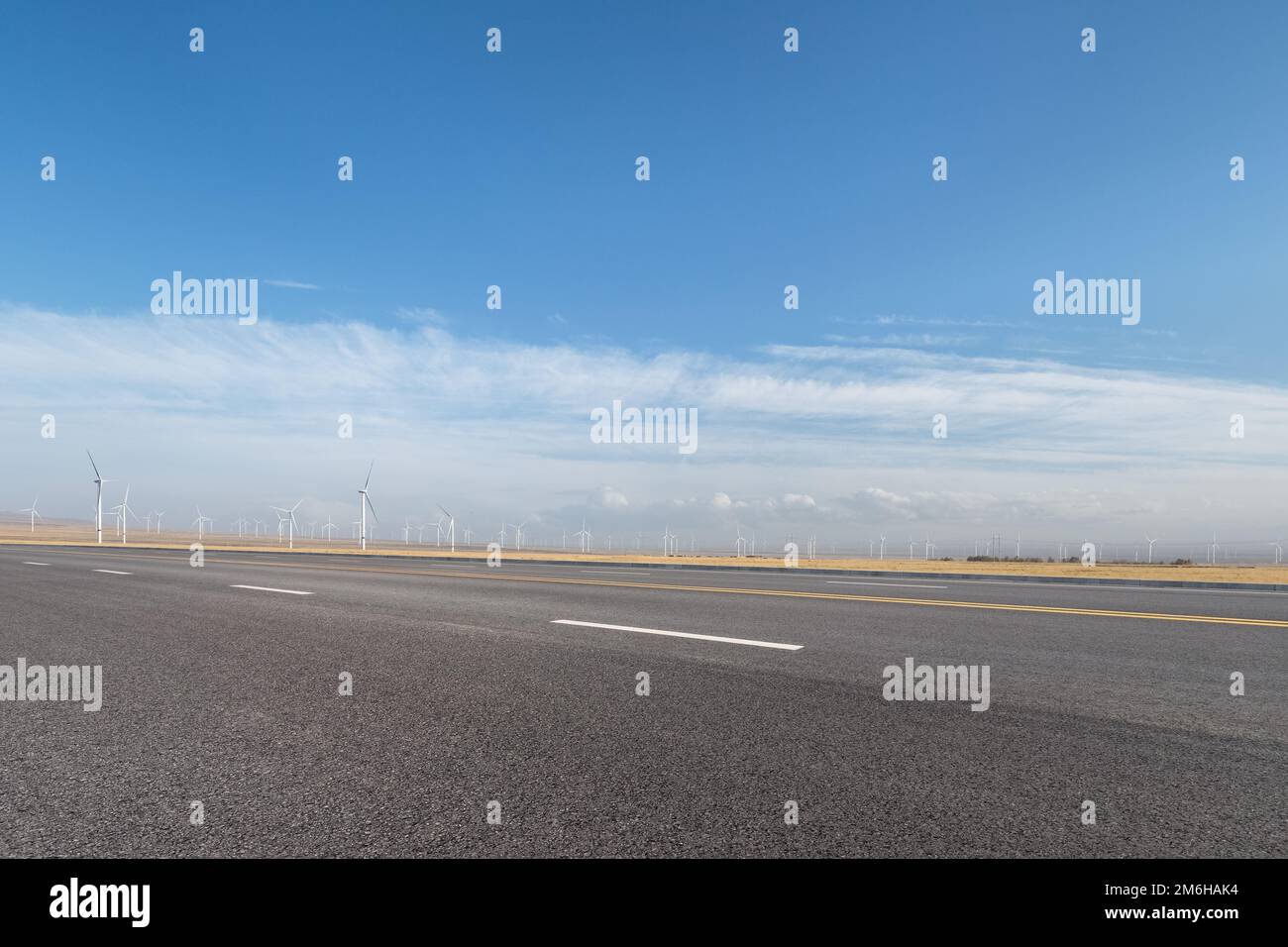 Empty asphalt road with wind farm Stock Photo