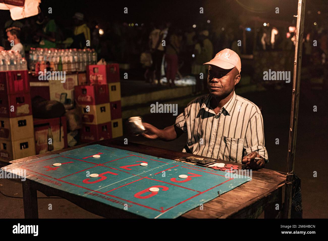 Man with gambling, Boulevard Poincare folk festival, Night, Mahajanga, Madagascar Stock Photo