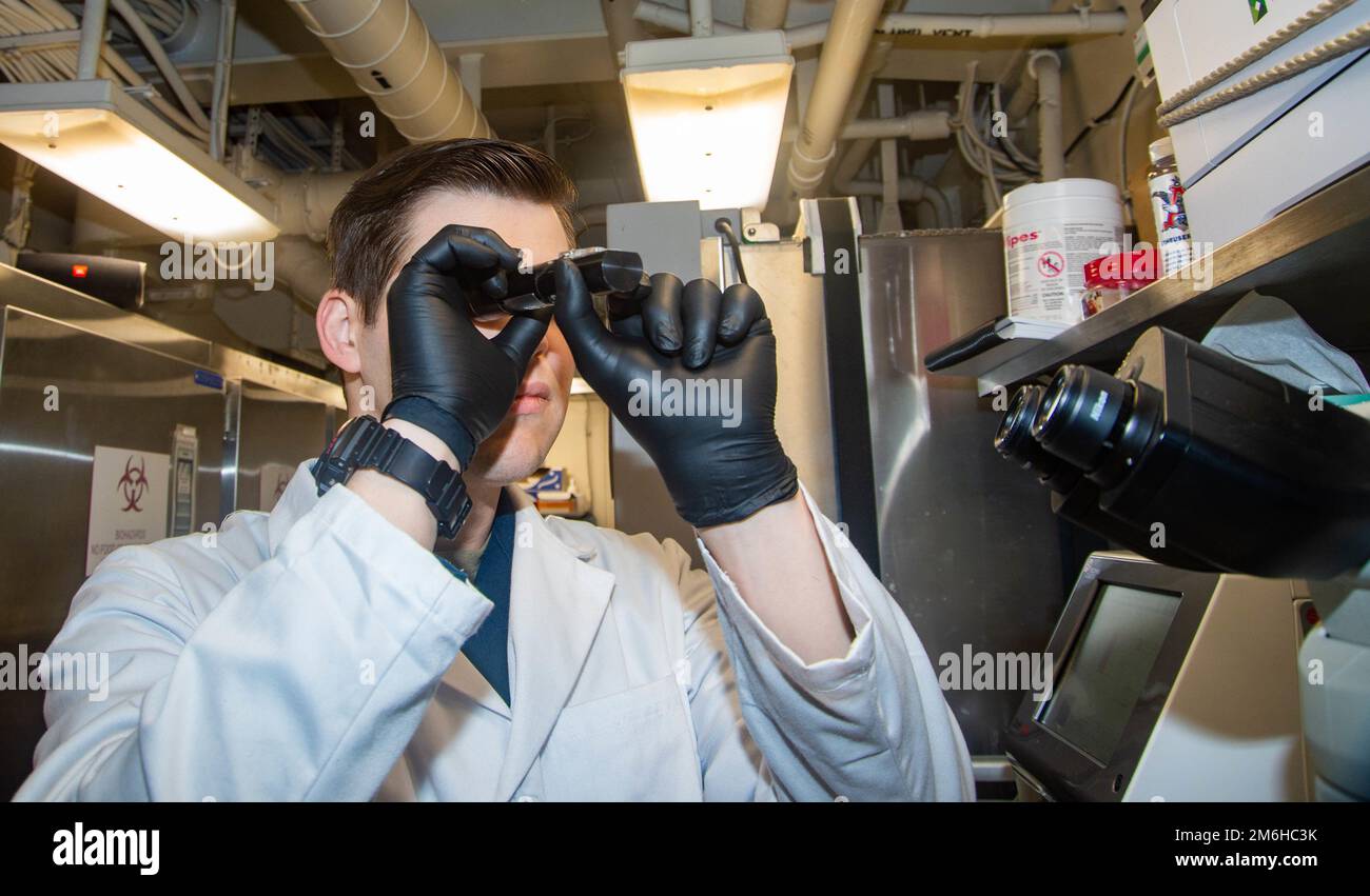 220428-N-TO573-1033 ADRIATIC SEA (April 28, 2022) Hospital Corspman 2nd Class J.D. Byrum, from Maiden, North Carolina, runs quality control on a hematology analyzer aboard the Nimitz-class aircraft carrier USS Harry S. Truman (CVN 75), April 28, 2022. The Harry S. Truman Carrier Strike Group is on a scheduled deployment in the U.S. Sixth Fleet area of operations in support of U.S., allied and partner interests in Europe and Africa. Stock Photo