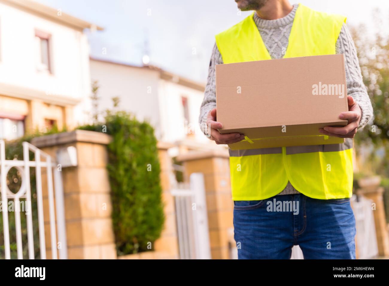Package delivery carrier with a box from an online store, delivering to