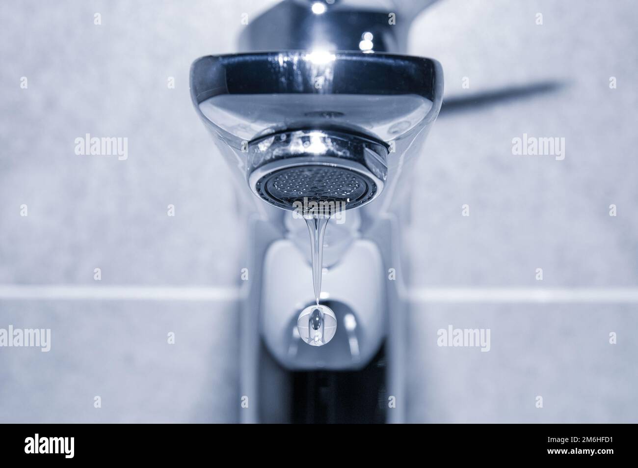 Water drop close up dripping from chrome faucet Stock Photo Alamy