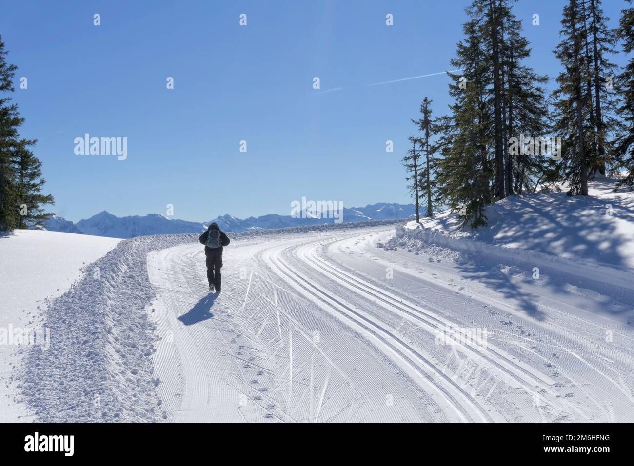 Wonderful wintertime, winter mountain landscape, sunny day. Single hiker explore the mountain route in Salzburg Alps. Active lifestyle in winter. Stock Photo