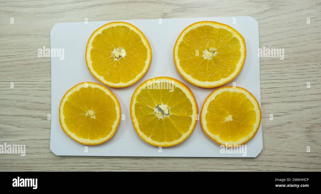 Sliced oranges for drying on paper Stock Photo