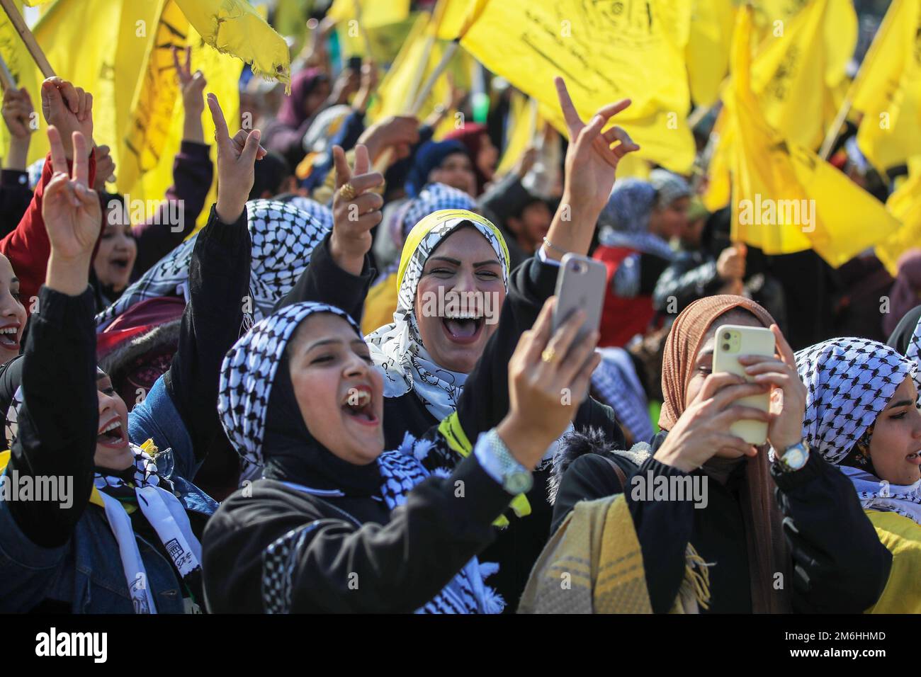 Palestinians attend a rally marking the 58th anniversary of the Fatah