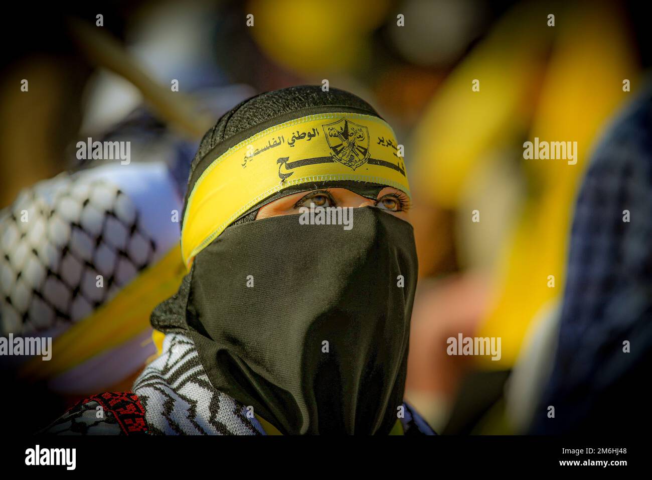 Palestinians attend a rally marking the 58th anniversary of the Fatah