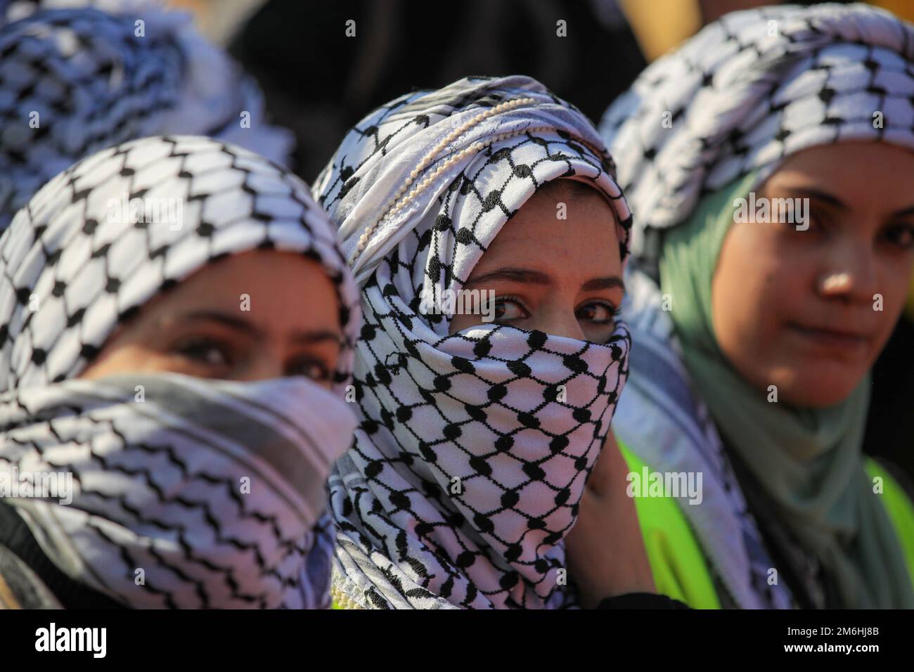Palestinians attend a rally marking the 58th anniversary of the Fatah