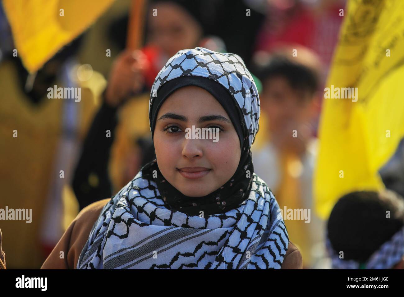Palestinians attend a rally marking the 58th anniversary of the Fatah