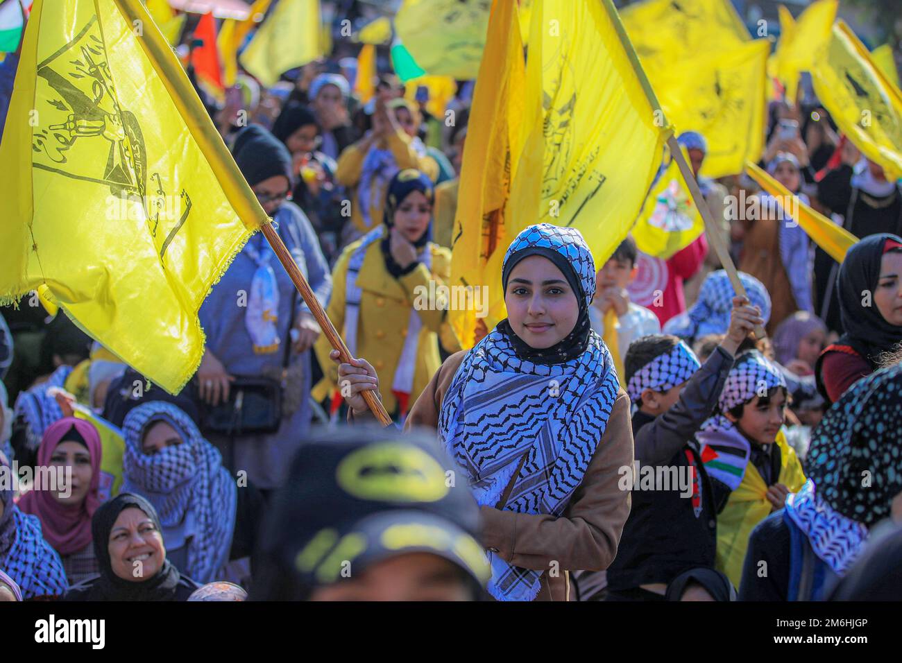 Palestinians attend a rally marking the 58th anniversary of the Fatah