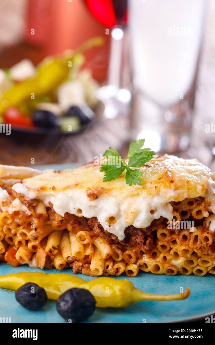 Greek pastitsio on blue plate Stock Photo