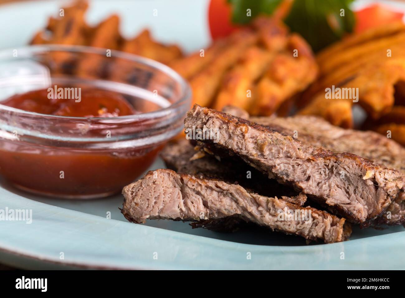 Sliced steak with potato grids Stock Photo