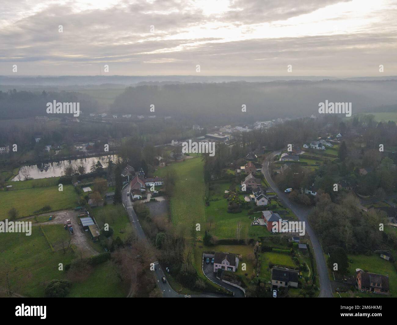 Aerial view of houses surrounded by forest in the country side area of