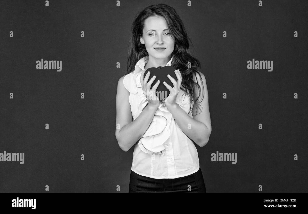 woman hold red love heart on black background, valentines day Stock
