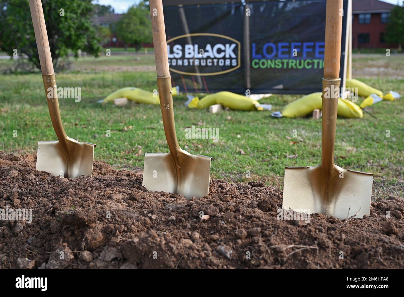 A row of shovels rests at the site of a new dormitory construction project during a groundbreaking ceremony at Little Rock Air Force Base, Arkansas, April 28, 2022. The $32 million project will construct two three-story permanent party enlisted dormitories to house 136 E-1 to E-4 military personnel in single occupancy dorms. Stock Photo
