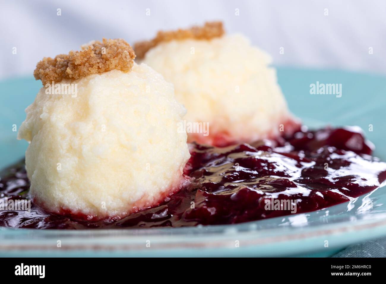 Austrian curd cheese dumplings on plum sauce Stock Photo