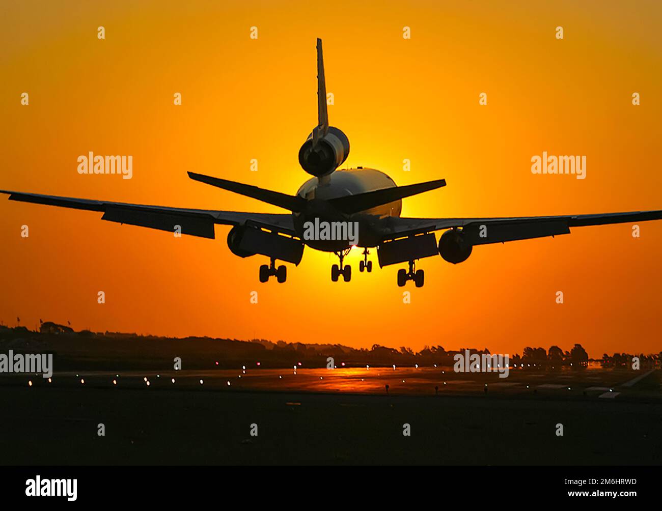 Takeoff of a passenger plane on the background of a sunset. Stock Photo