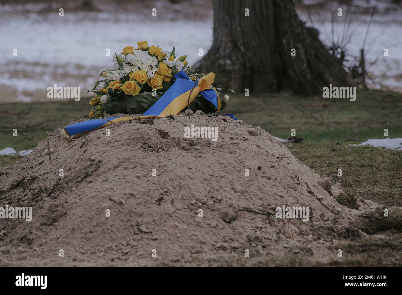 One recently dug grave with burial ornament Stock Photo