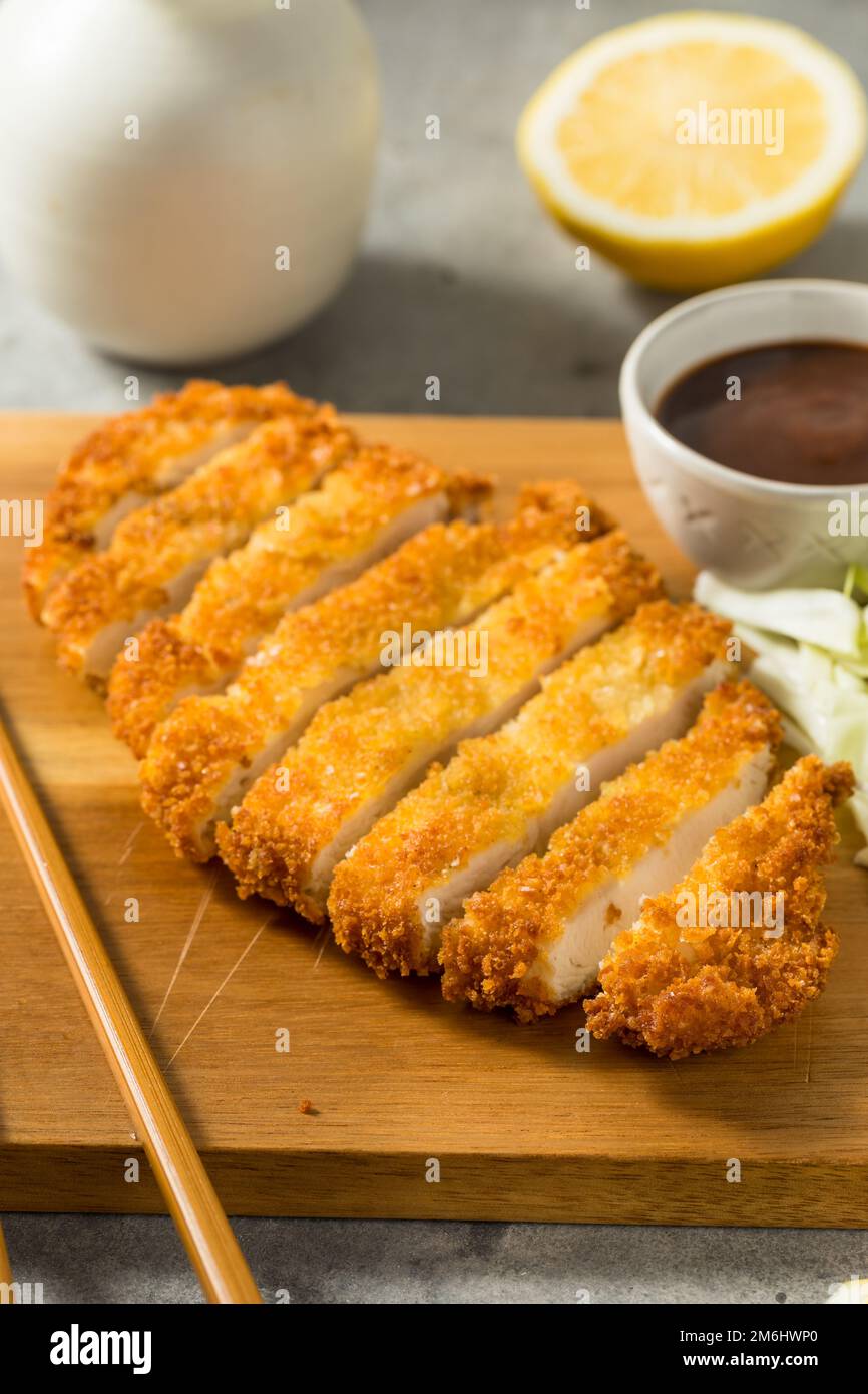 Homemade Japanese Chicken Tonkatsu with Cabbage and Lemon Stock Photo