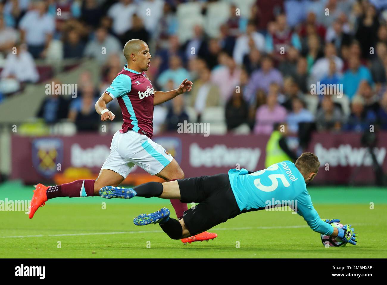 Axel Maraval of NK Domzale grabs the ball with Sofiane Feghouli of West Ham United clean through on goal - West Ham United v NK Domzale, UEFA Europa League second leg third round qualifier, The London Stadium, Stratford, London - 06 August 2016.Picture by Richard Calver Stock Photo