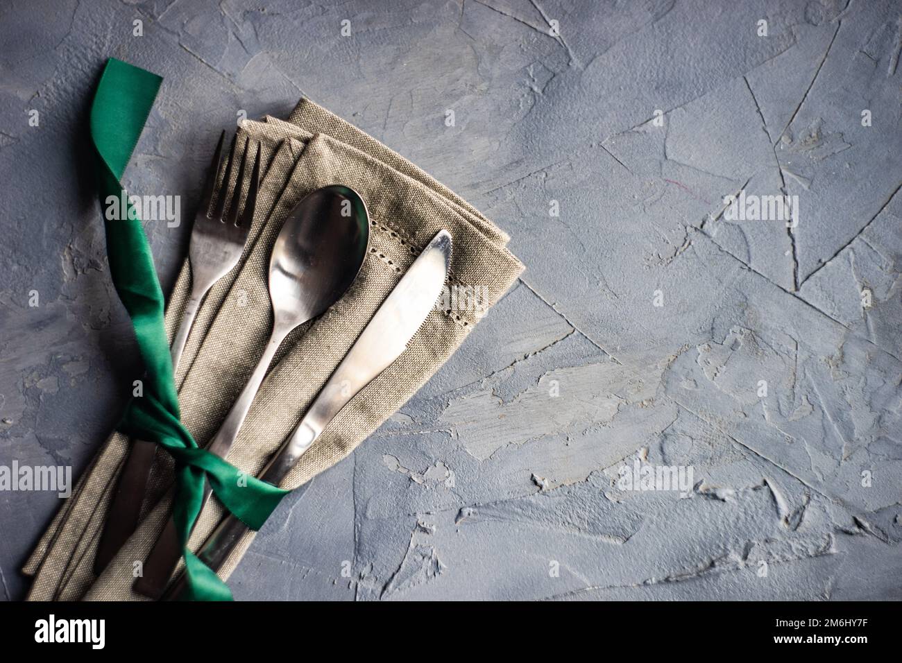Cutlery set with green ribbon Stock Photo