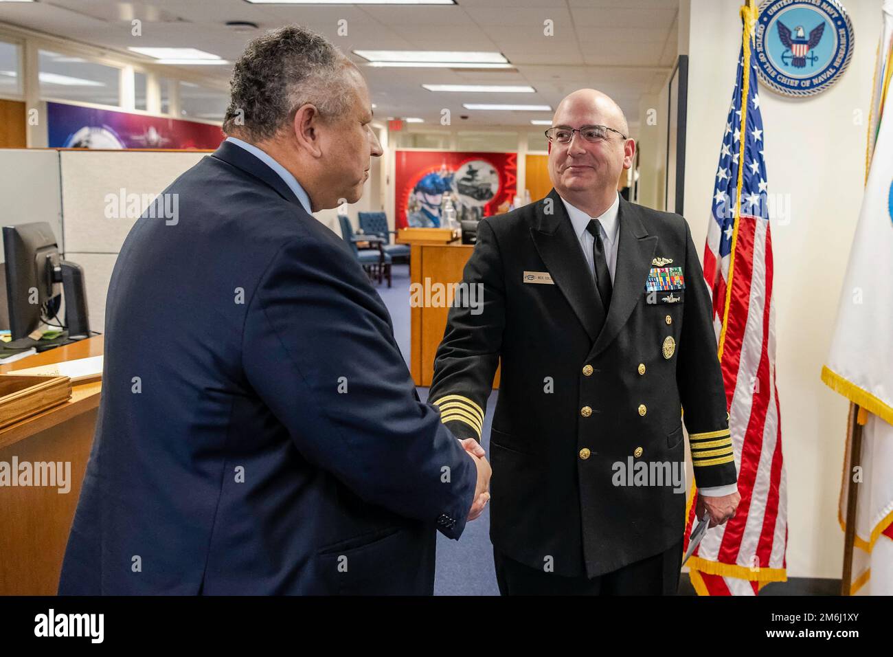 SECNAV Carlos Del Toro (left) is welcomed to the ONR front office by ACNR Capt. Neil Colston (right).    SECNAV was briefed on a broad range of topics by the team at the Office of Naval Research including the Future Naval Capabilities (FNC) and Innovative Naval Prototype (INP) portfolios to increase capabilities of Marines and Sailors, STEM outreach, and ONR's overall global reach and involvement. Stock Photo